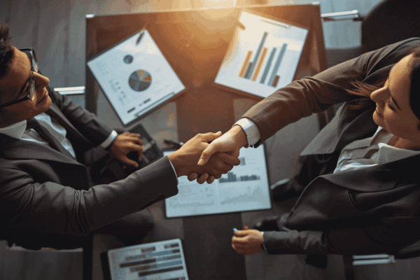 Executives forming joint venture partnership in boardroom