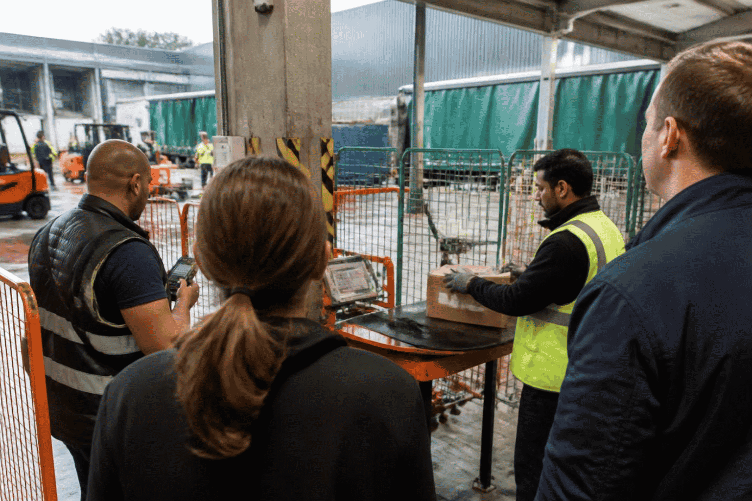 Startup founder observing an enterprise technology pilot at a logistics facility