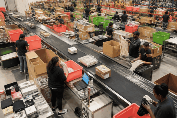 Retail employees sorting returned products for restocking, refurbishment, and recycling