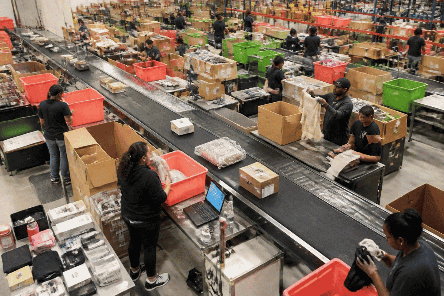 Retail employees sorting returned products for restocking, refurbishment, and recycling
