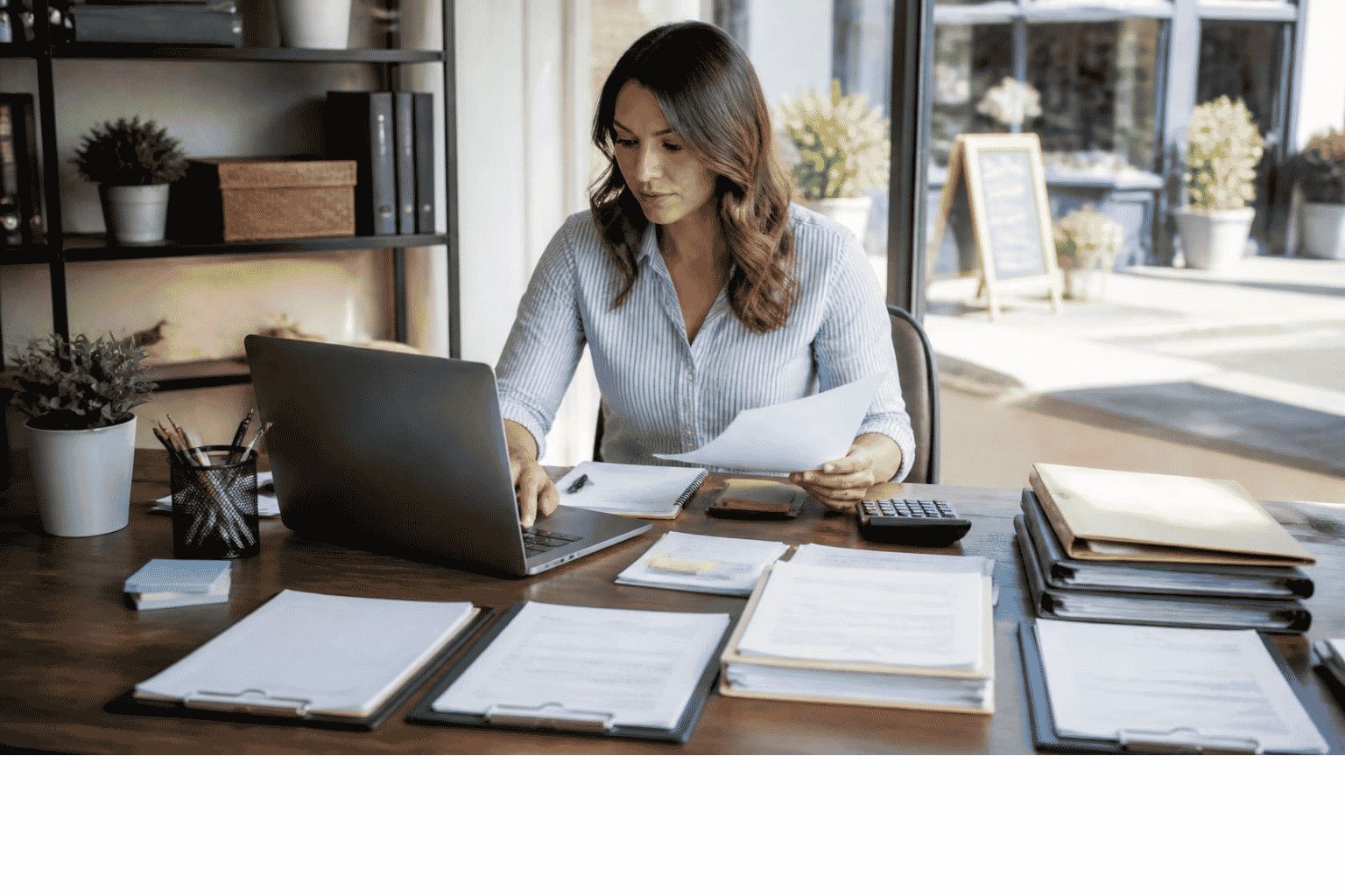 Business owner organizing lender ready information before applying for business funding