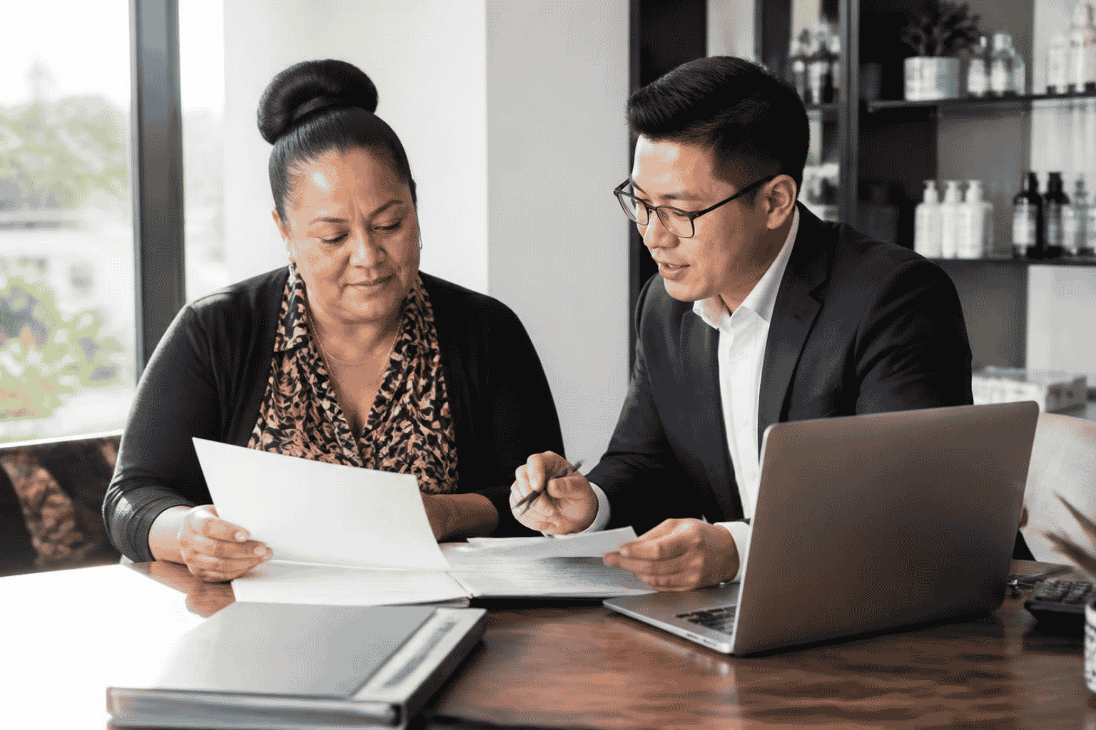 Business owner reviewing line of credit qualification documents and financial statements